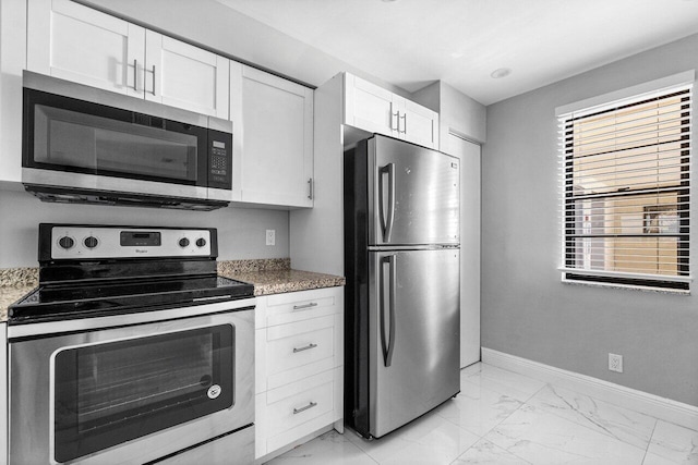 kitchen featuring stone counters, white cabinets, and appliances with stainless steel finishes