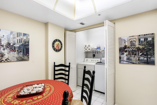 tiled dining area with washing machine and dryer