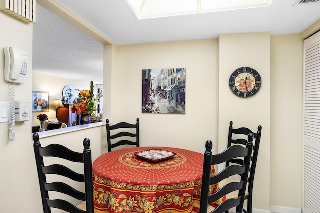 dining space with a textured ceiling