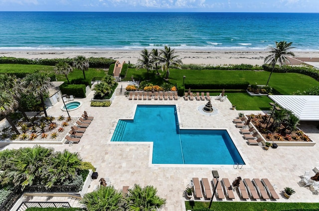 bird's eye view featuring a water view and a beach view