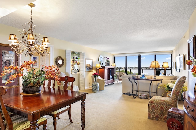 carpeted dining space featuring floor to ceiling windows, an inviting chandelier, and a textured ceiling