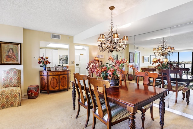 carpeted dining space featuring a textured ceiling and a chandelier