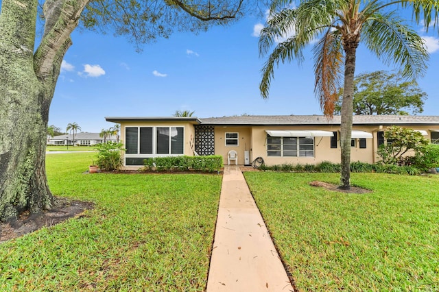 ranch-style home with a front lawn