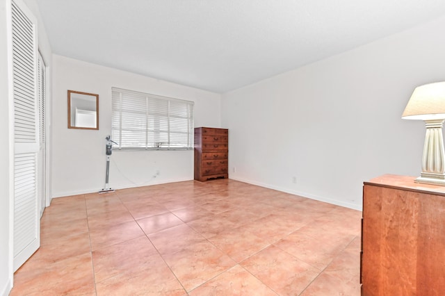 unfurnished room with light tile patterned floors