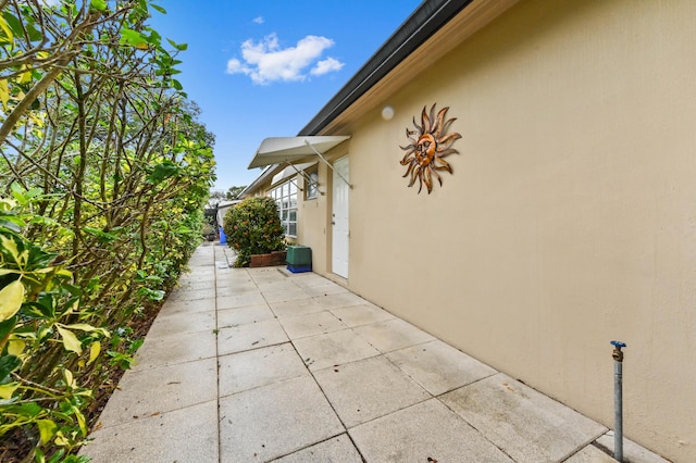 view of side of home with a patio