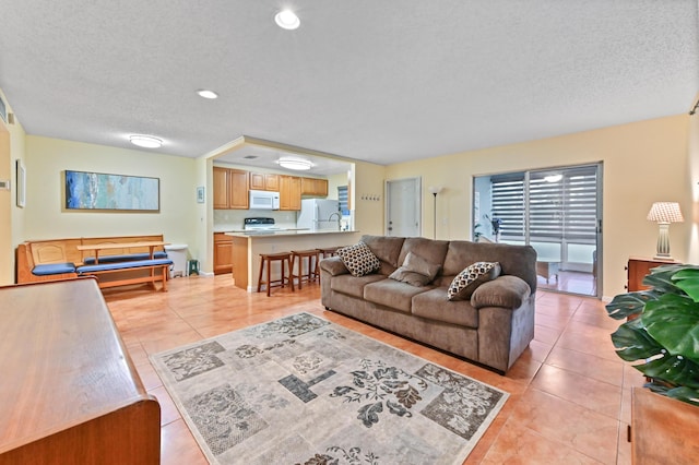 tiled living room with a textured ceiling