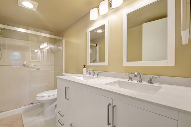 bathroom featuring tile patterned flooring, vanity, an enclosed shower, and toilet