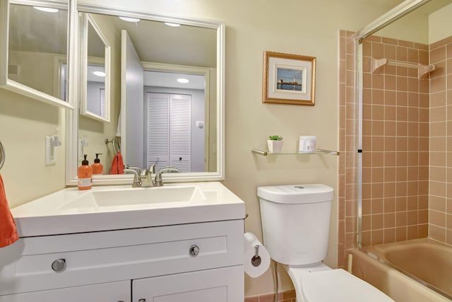 full bathroom with vanity, toilet, and tiled shower / bath combo