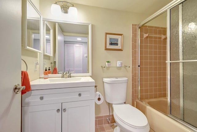 full bathroom featuring tile patterned flooring, vanity, bath / shower combo with glass door, and toilet