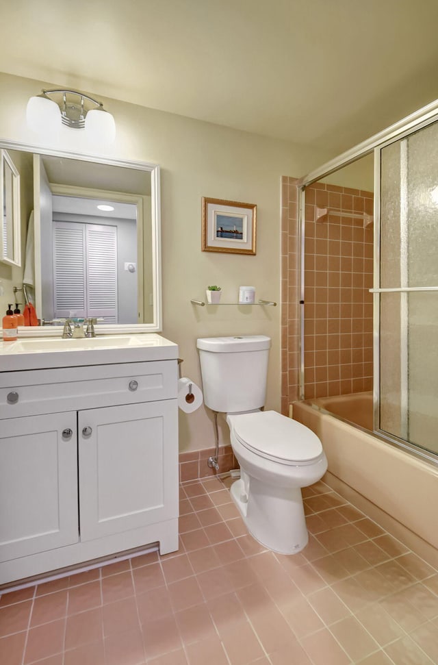 full bathroom with vanity, tile patterned floors, toilet, and combined bath / shower with glass door