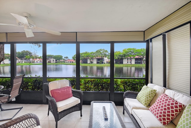 sunroom / solarium featuring a water view and ceiling fan