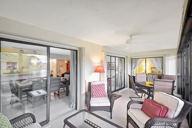 sunroom featuring ceiling fan