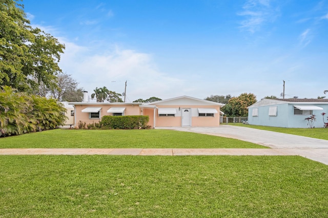 ranch-style home featuring a front yard