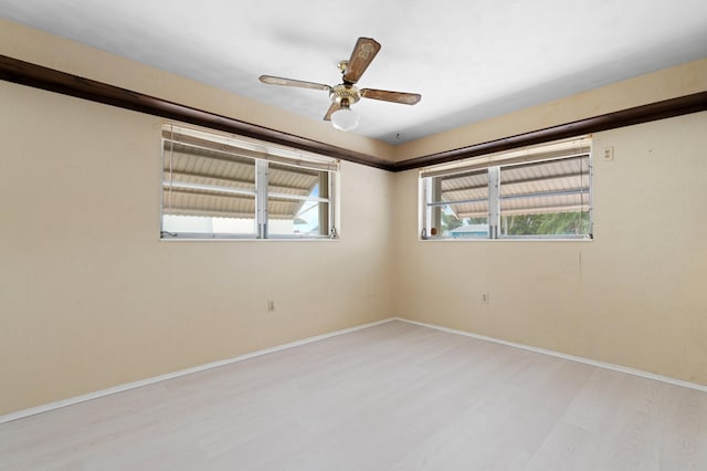 unfurnished room with light wood-type flooring and ceiling fan