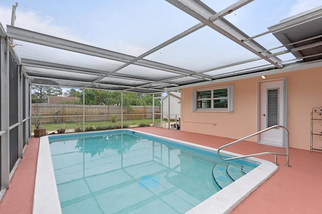 view of swimming pool with a patio area and a lanai