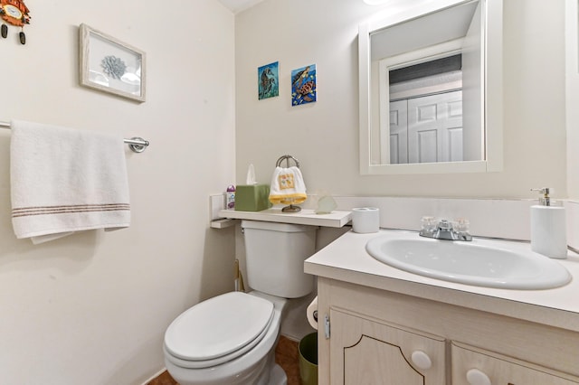 bathroom featuring toilet and vanity