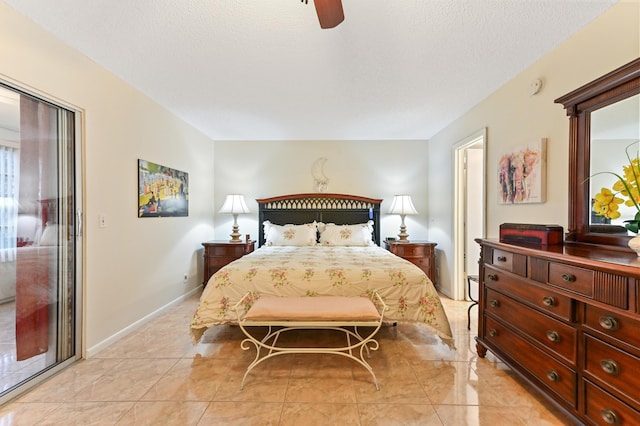 bedroom featuring ceiling fan and a textured ceiling