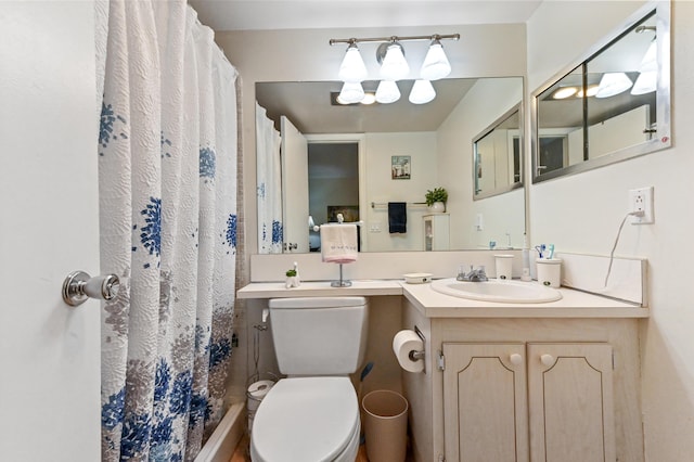 bathroom with toilet, vanity, and walk in shower