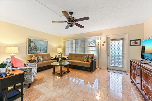 living room featuring a textured ceiling and ceiling fan