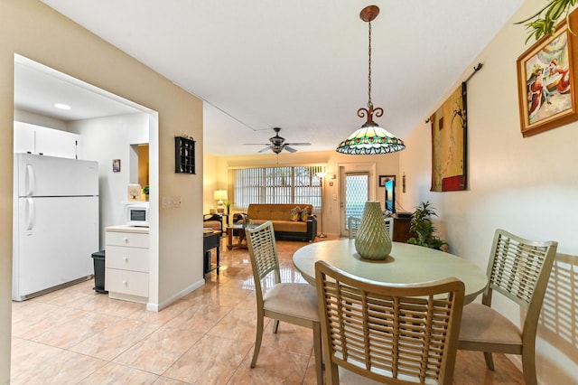 dining area featuring ceiling fan and light tile patterned floors