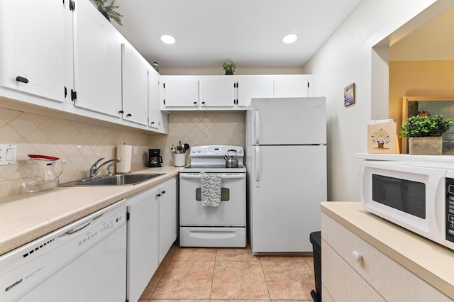 kitchen featuring sink, backsplash, white cabinetry, and white appliances