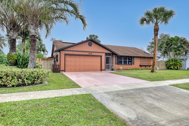 single story home with driveway, a front lawn, an attached garage, and fence