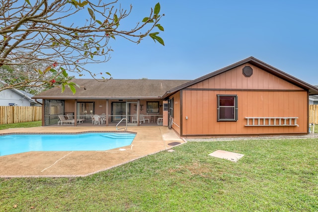 view of pool with a fenced in pool, a patio, a sunroom, fence, and a yard