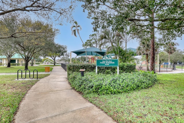 view of home's community featuring a lawn and fence