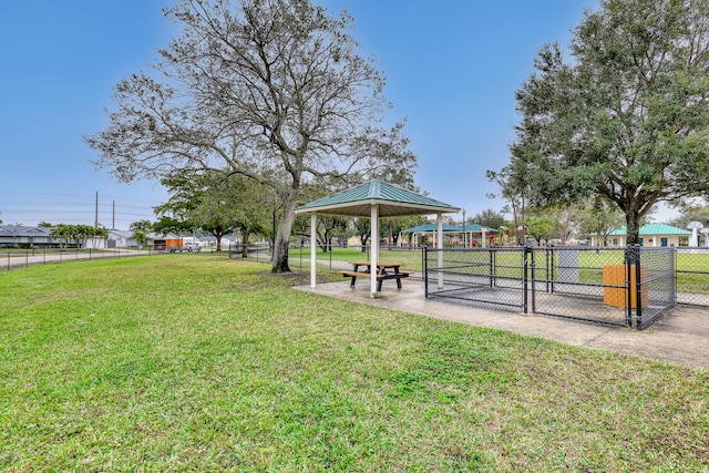 surrounding community with a yard, fence, and a gazebo