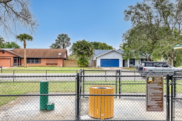 view of front of house featuring a front yard, concrete driveway, and fence