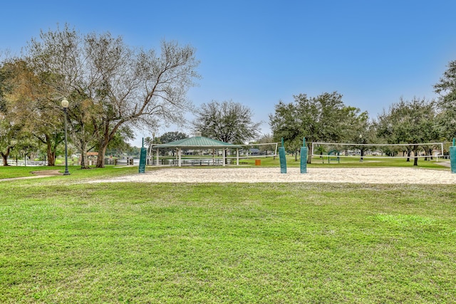 view of property's community with volleyball court, a yard, and a gazebo