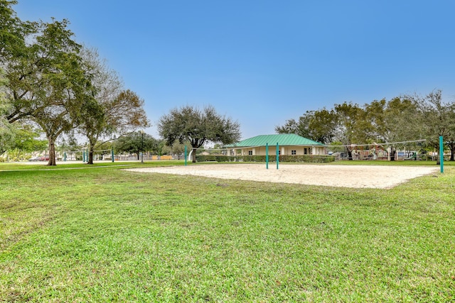 surrounding community with volleyball court and a yard