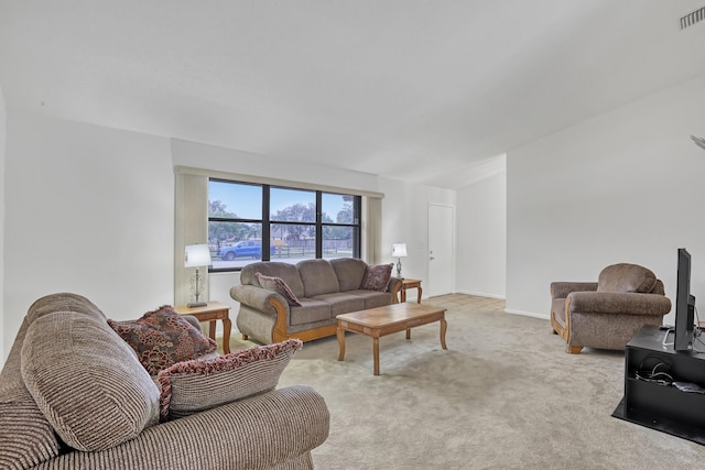 living room with light carpet, visible vents, and baseboards