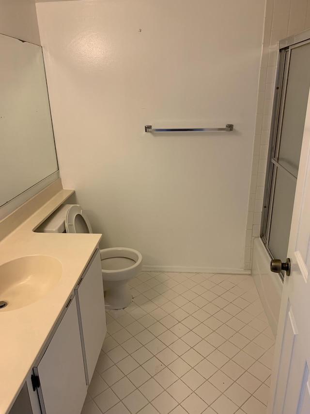 full bathroom featuring toilet, bath / shower combo with glass door, tile patterned flooring, and vanity