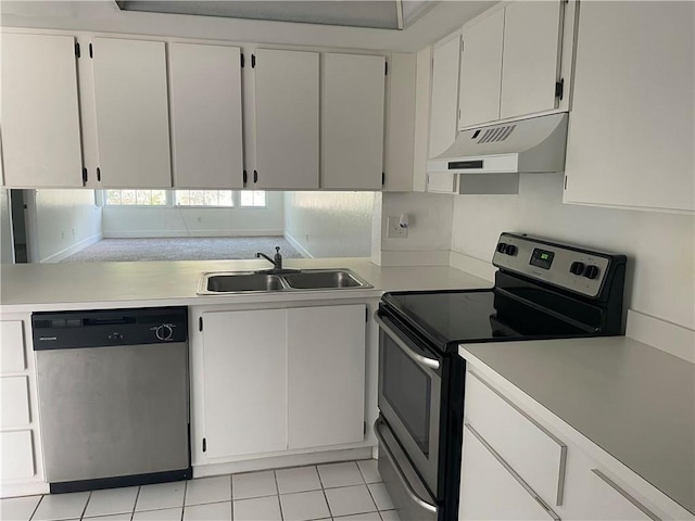 kitchen featuring light tile patterned floors, appliances with stainless steel finishes, white cabinetry, and sink