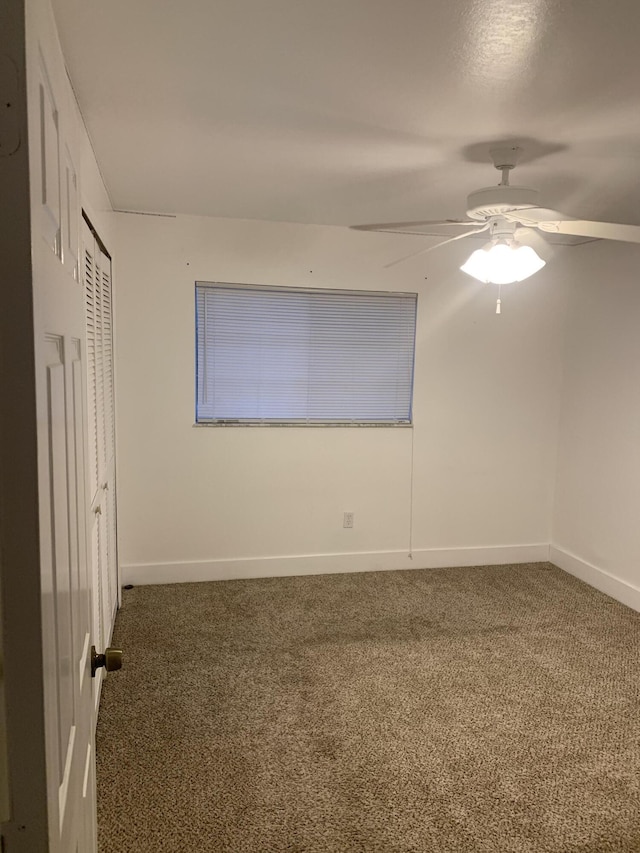 carpeted empty room featuring ceiling fan