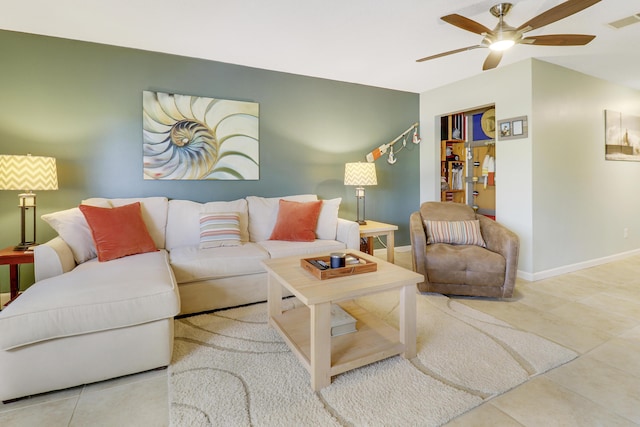 tiled living room with ceiling fan