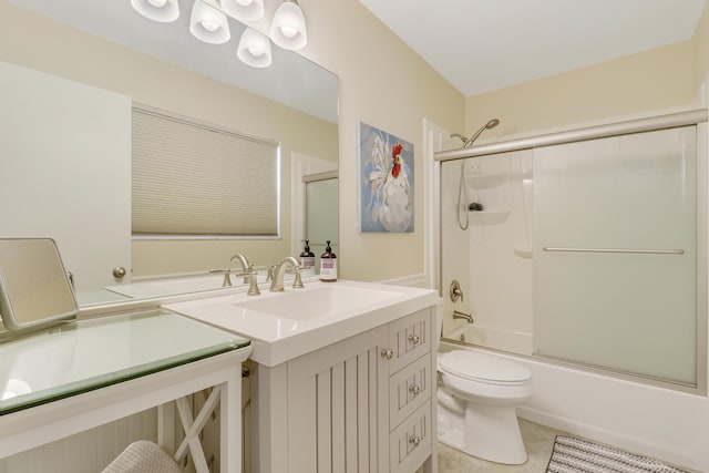 full bathroom with combined bath / shower with glass door, vanity, toilet, and tile patterned flooring