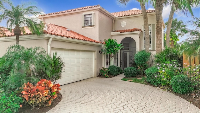 mediterranean / spanish-style home featuring a garage