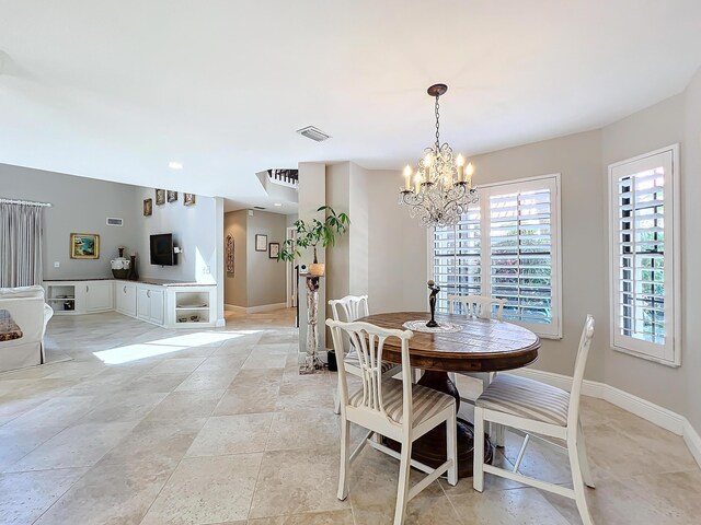 living room with a towering ceiling and an inviting chandelier