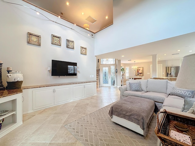 living room featuring a high ceiling and built in shelves