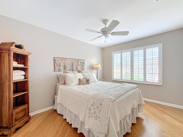 bedroom with ceiling fan and light hardwood / wood-style floors