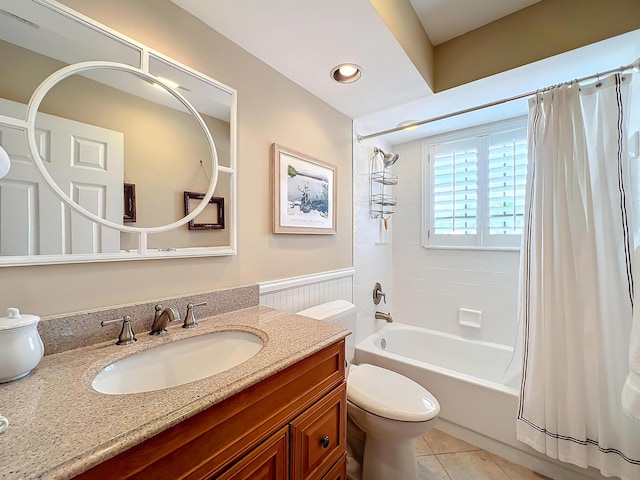 full bathroom with shower / bathtub combination with curtain, vanity, tile patterned flooring, and toilet