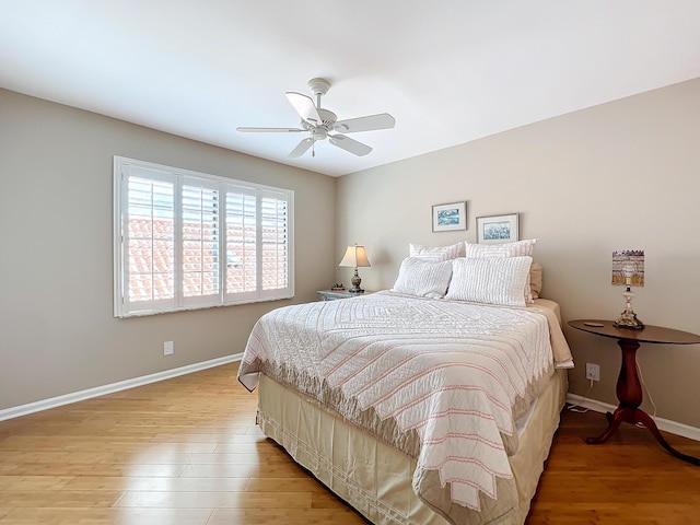 bedroom with ceiling fan and light hardwood / wood-style flooring