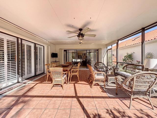 sunroom / solarium featuring ceiling fan