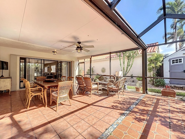 sunroom featuring ceiling fan, a skylight, and a healthy amount of sunlight