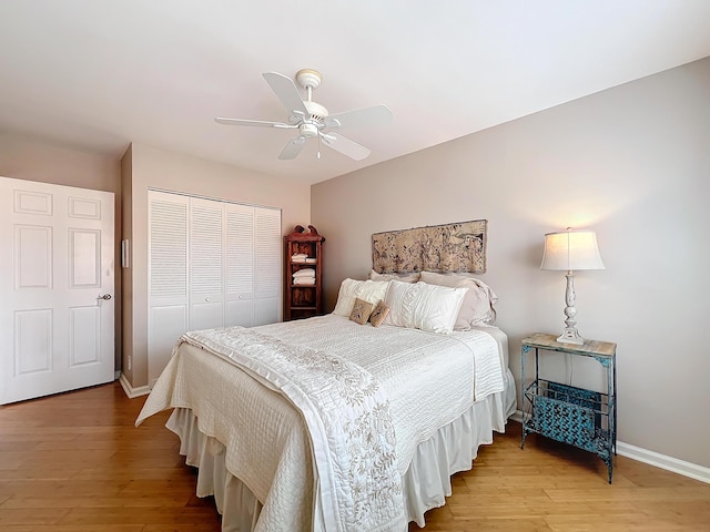 bedroom with ceiling fan, a closet, and light hardwood / wood-style flooring