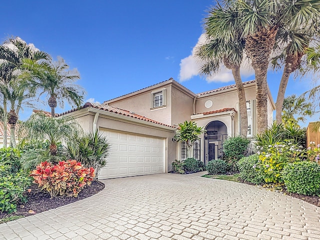 mediterranean / spanish-style home with a garage