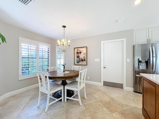 dining room with a notable chandelier