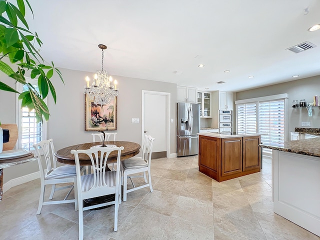 dining area featuring plenty of natural light and a chandelier